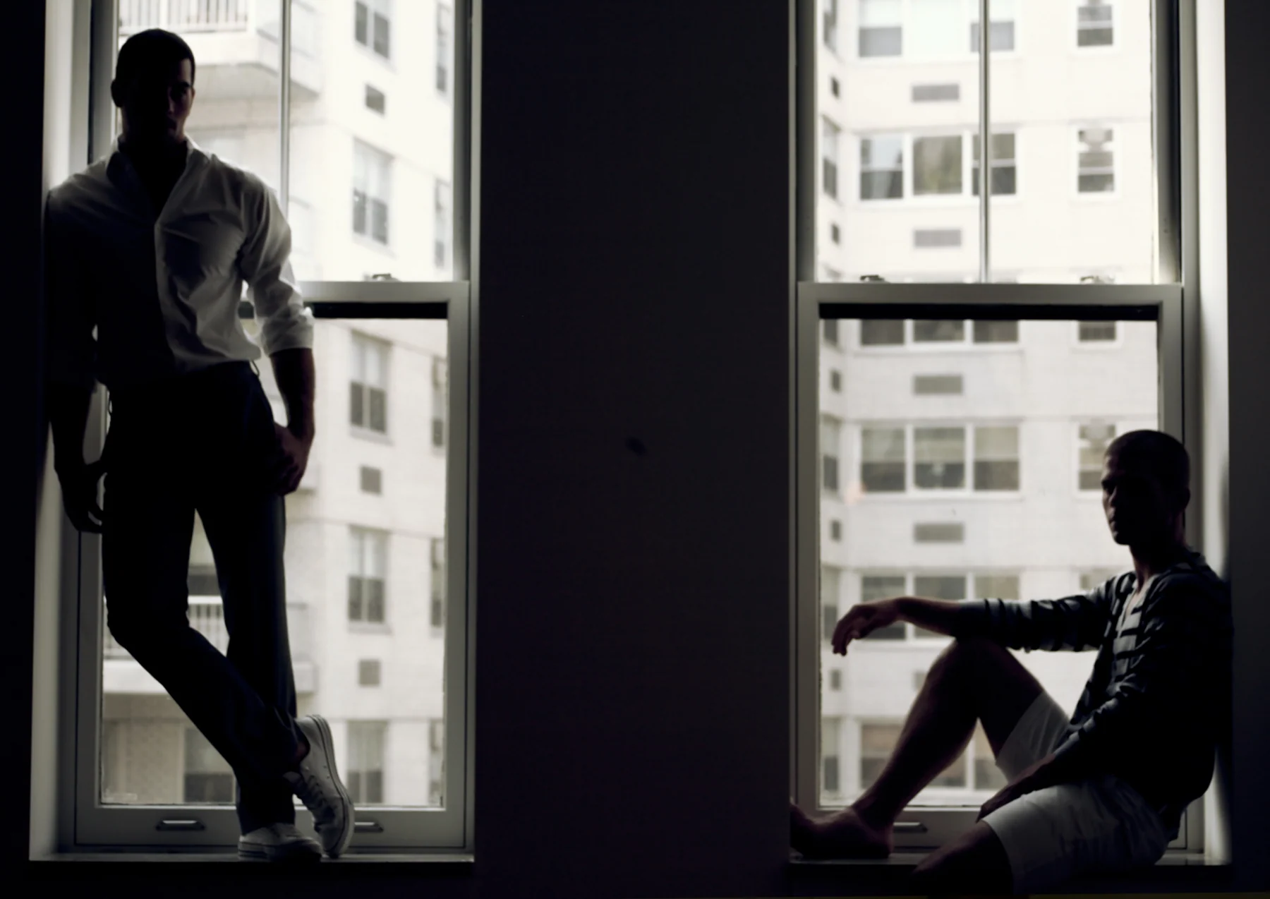 Two men beside windows