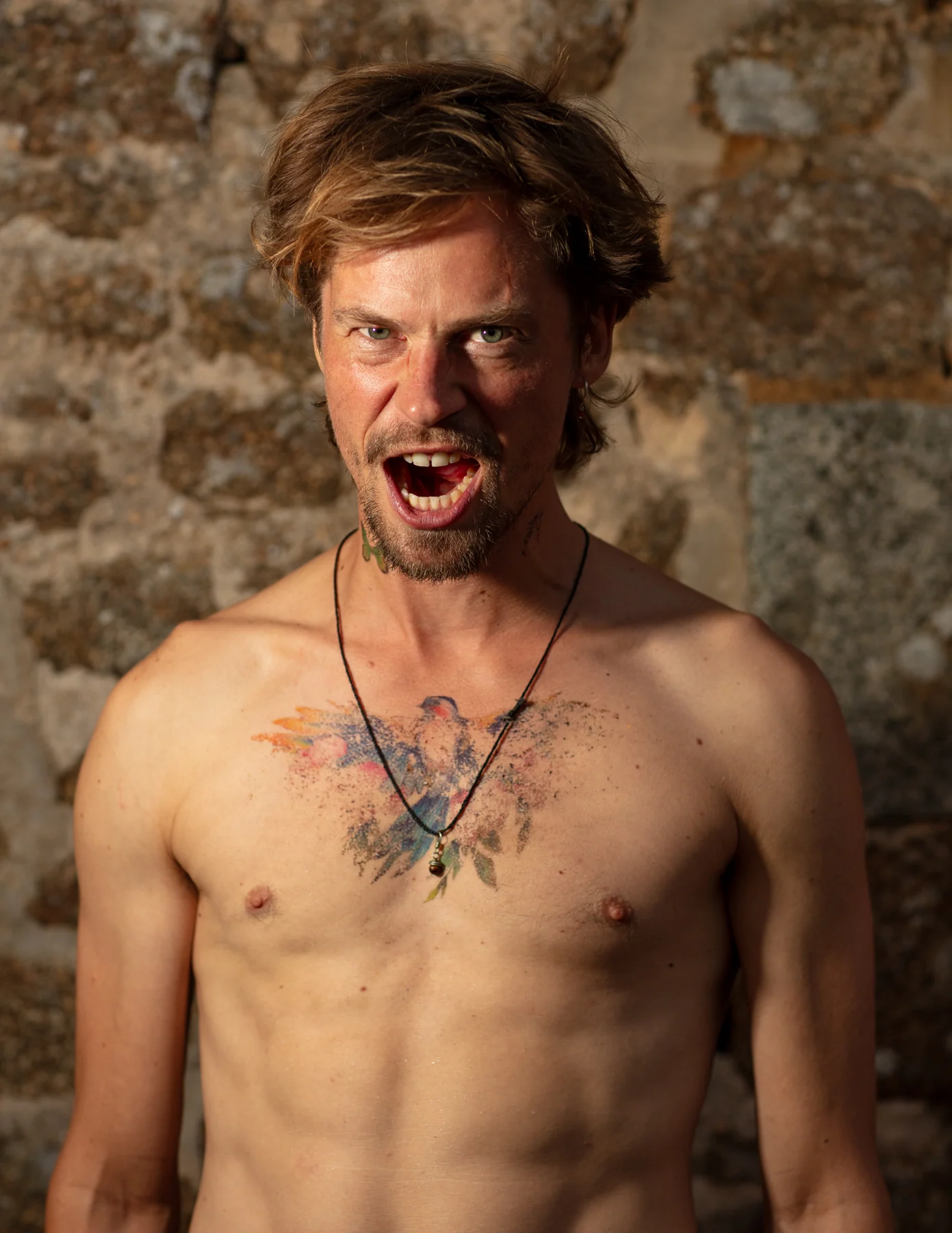 Open mouth beside a stone wall